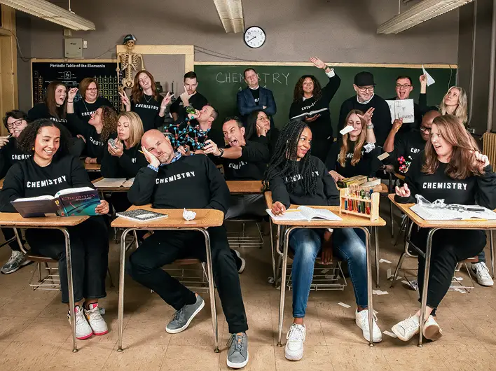 Chemistry employees goofing off in a classroom